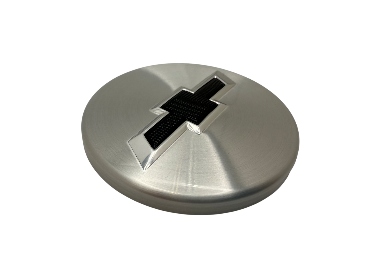 Chevy wheel badge utilizing screen printing, embossing and rolled edges