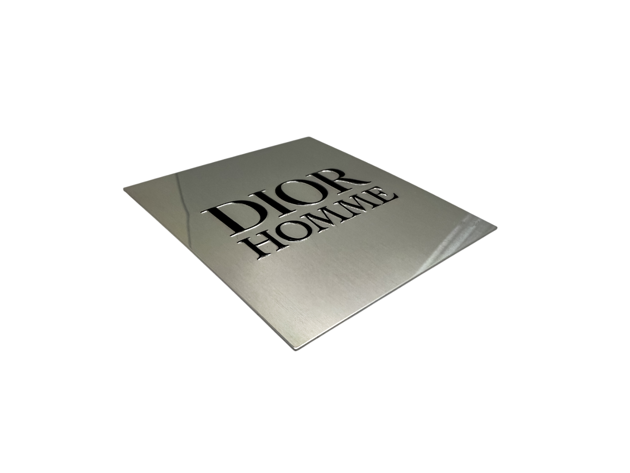 Dior nameplate with screen printed black lettering and embossing
