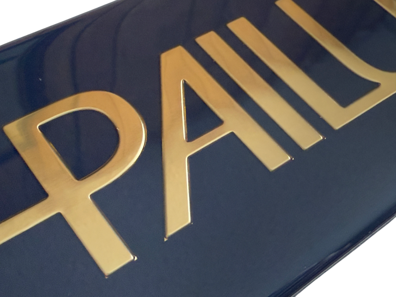 Polycarbonate nameplate with embossing, printing and a polyurethane resin dome