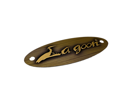 Aluminum stamped label used for furniture. Surface has been printed to mimic the appearance of brass