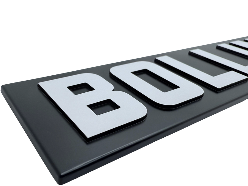 Injection molded badge produced using precision tooling showing molded shape and dimensional consistency