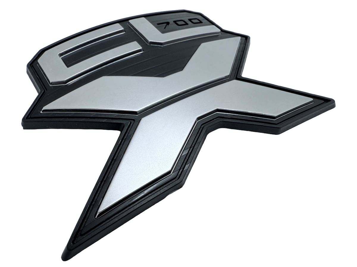 Injection molded plastic badges showing raised logo detail and consistent molded geometry