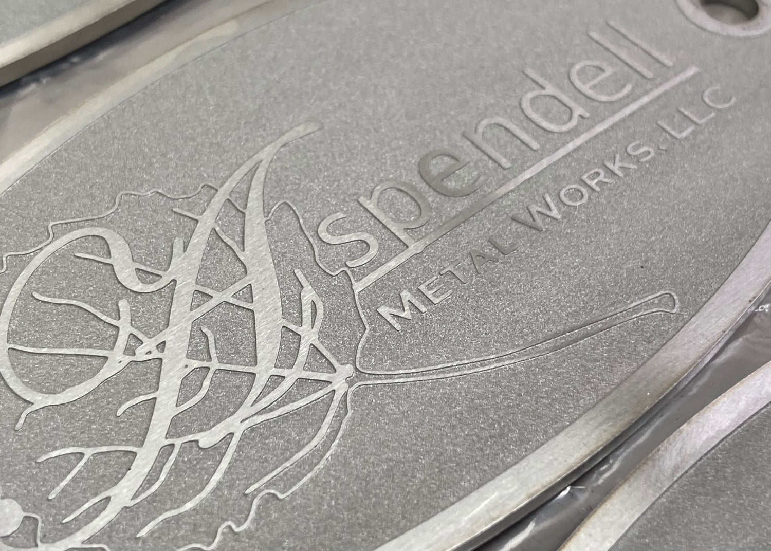 Custom badges with an etched surface for fire pits