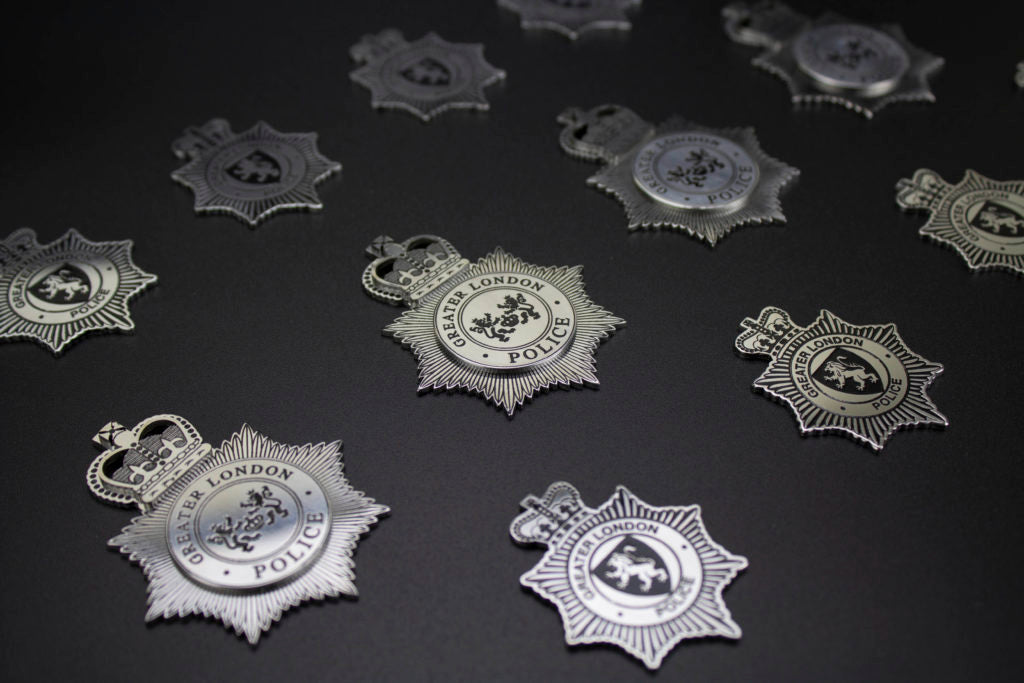 Chemically etched badges with antique finish to the surface