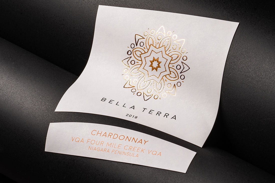 Cold foil label with a white background and a gold embossed design