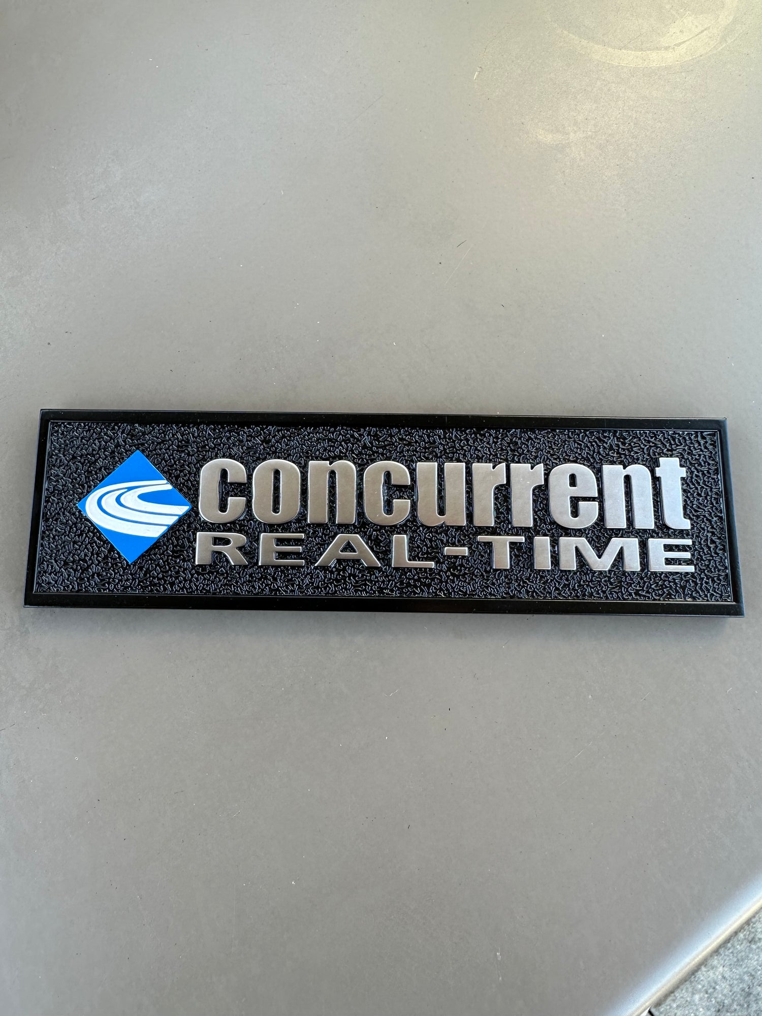 Thick black equipment nameplate with embossed surface