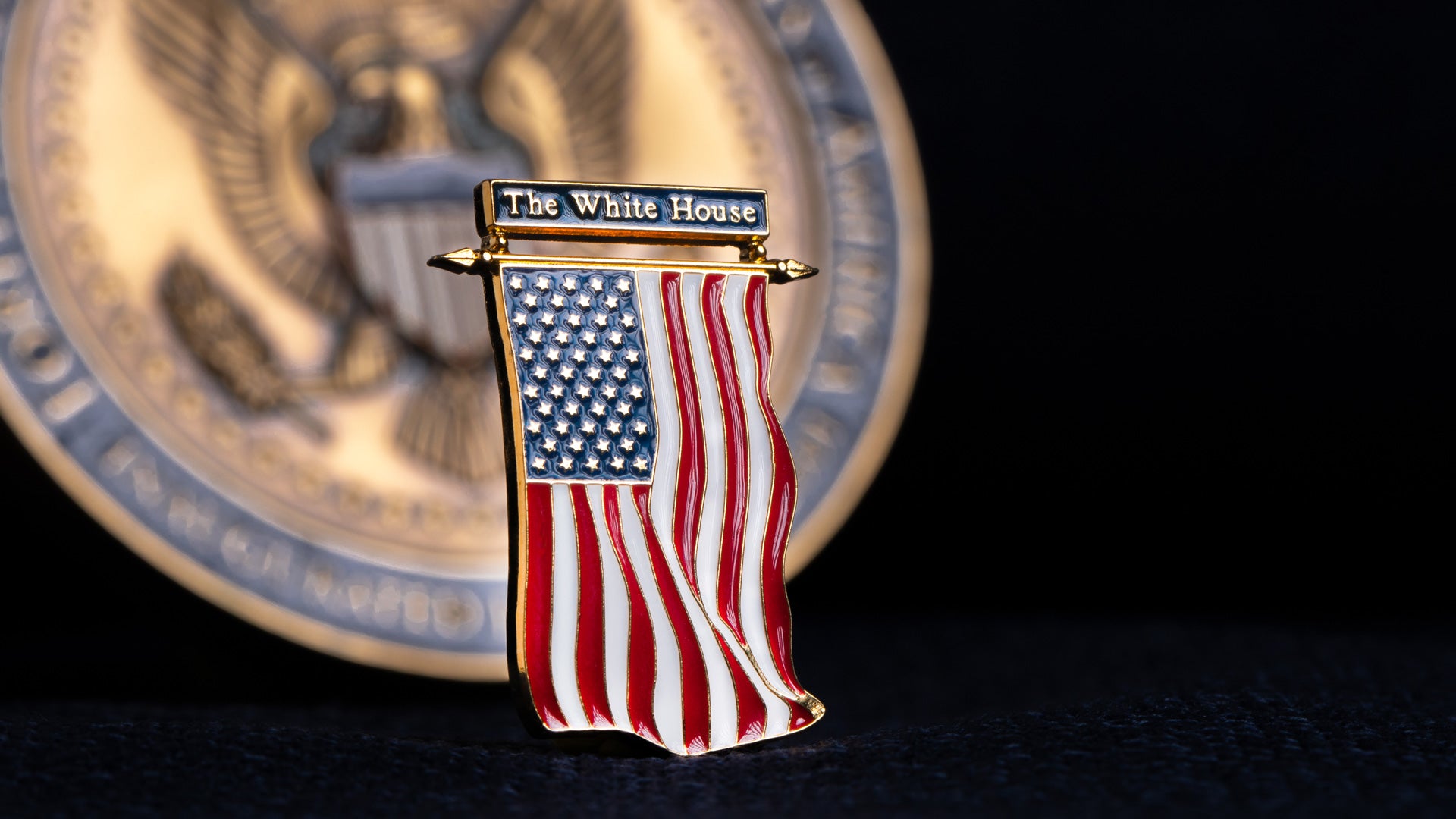 A US flag hard enamel pin made using metal stamping