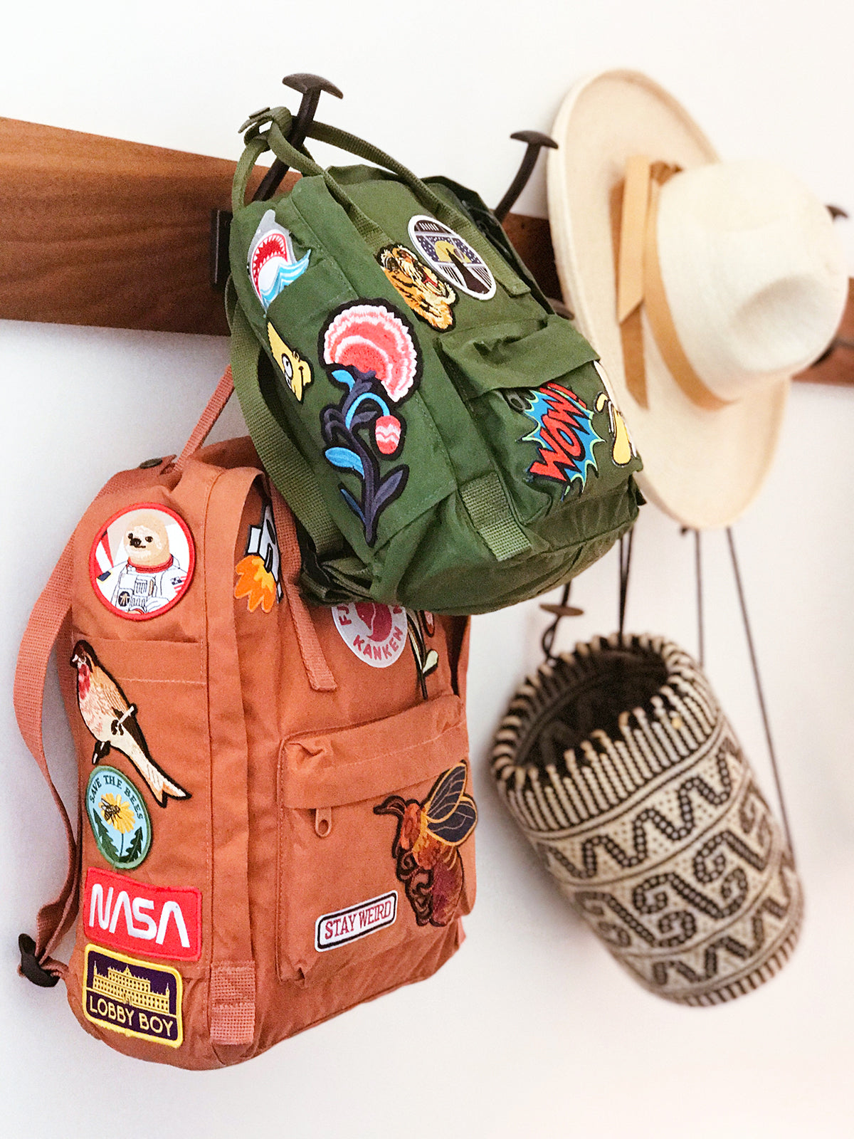 3 different backpacks with different types of patches attached