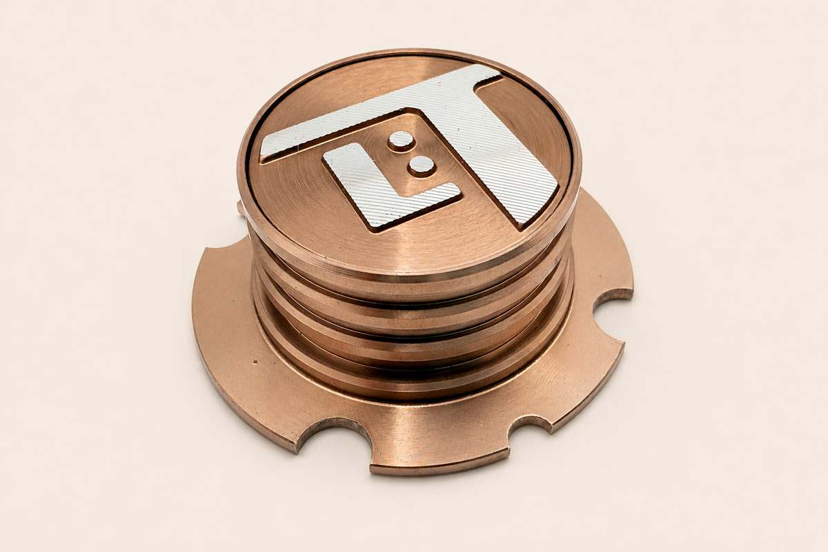 Forged aluminum electronics badge with anodizing and brushing