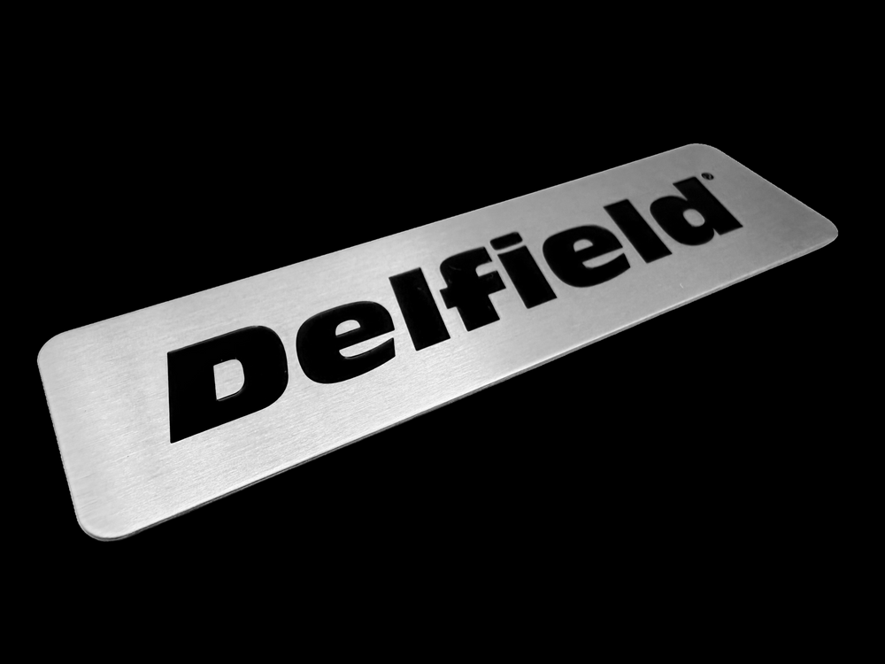 Delfield etched stainless steel machinery label with automotive grade black paint filling.