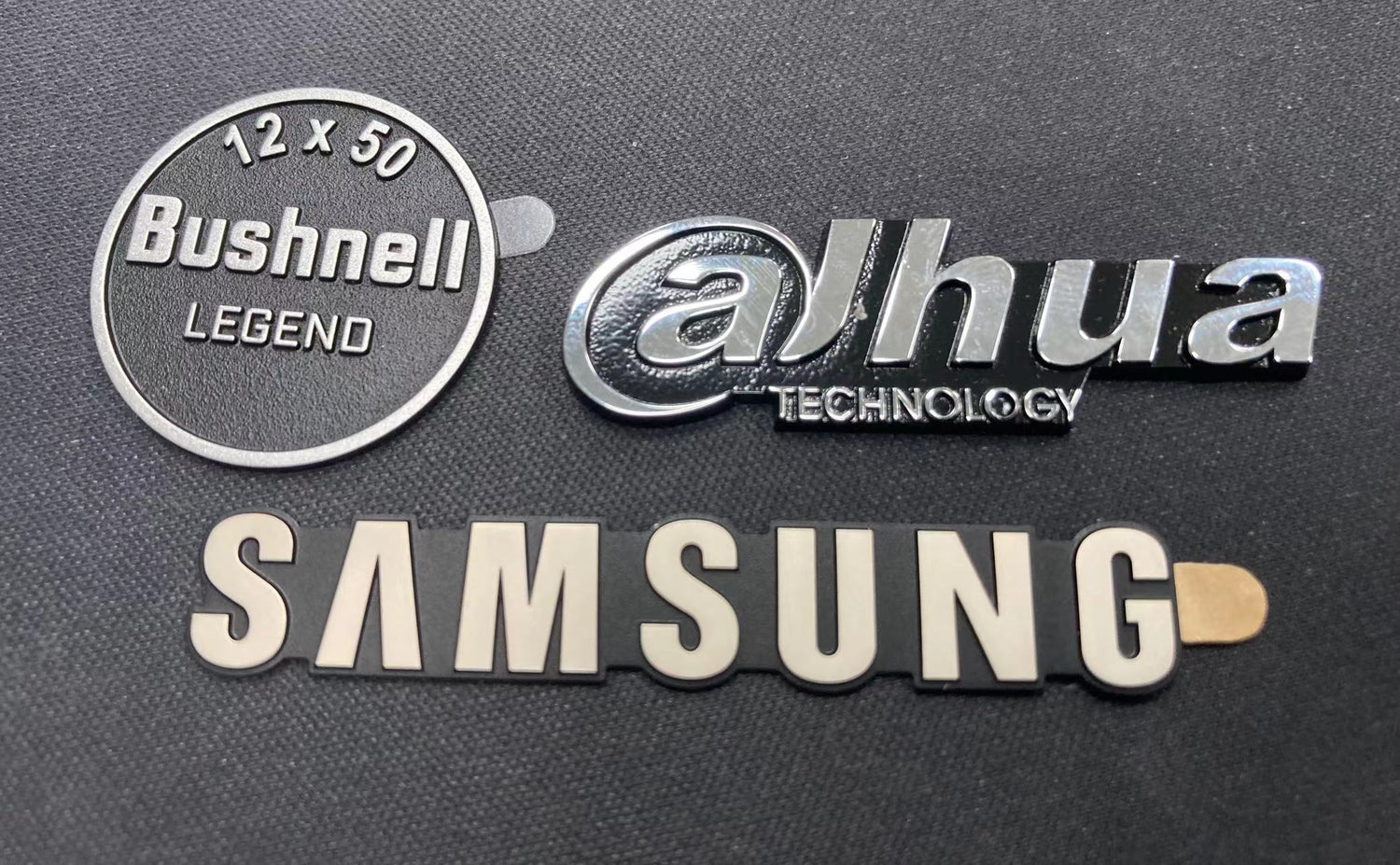Nameplates with an embossed or raised surface used to brand technology products.