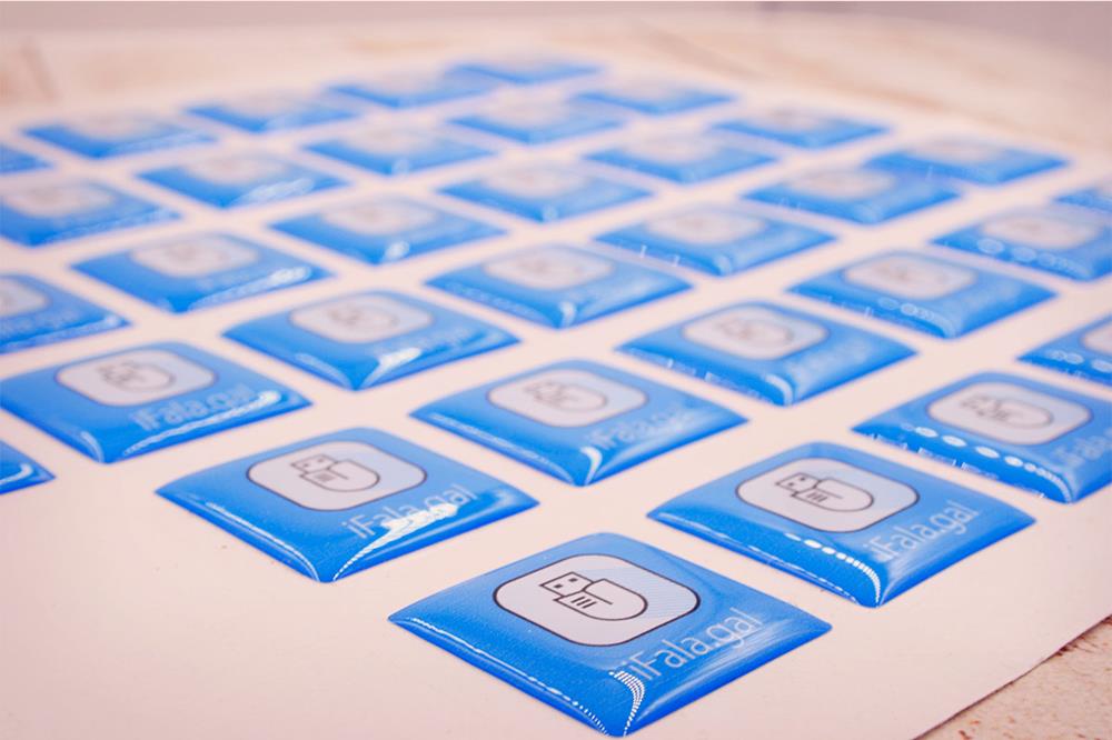 A sheet of epoxy dome labels with a blue and white surface