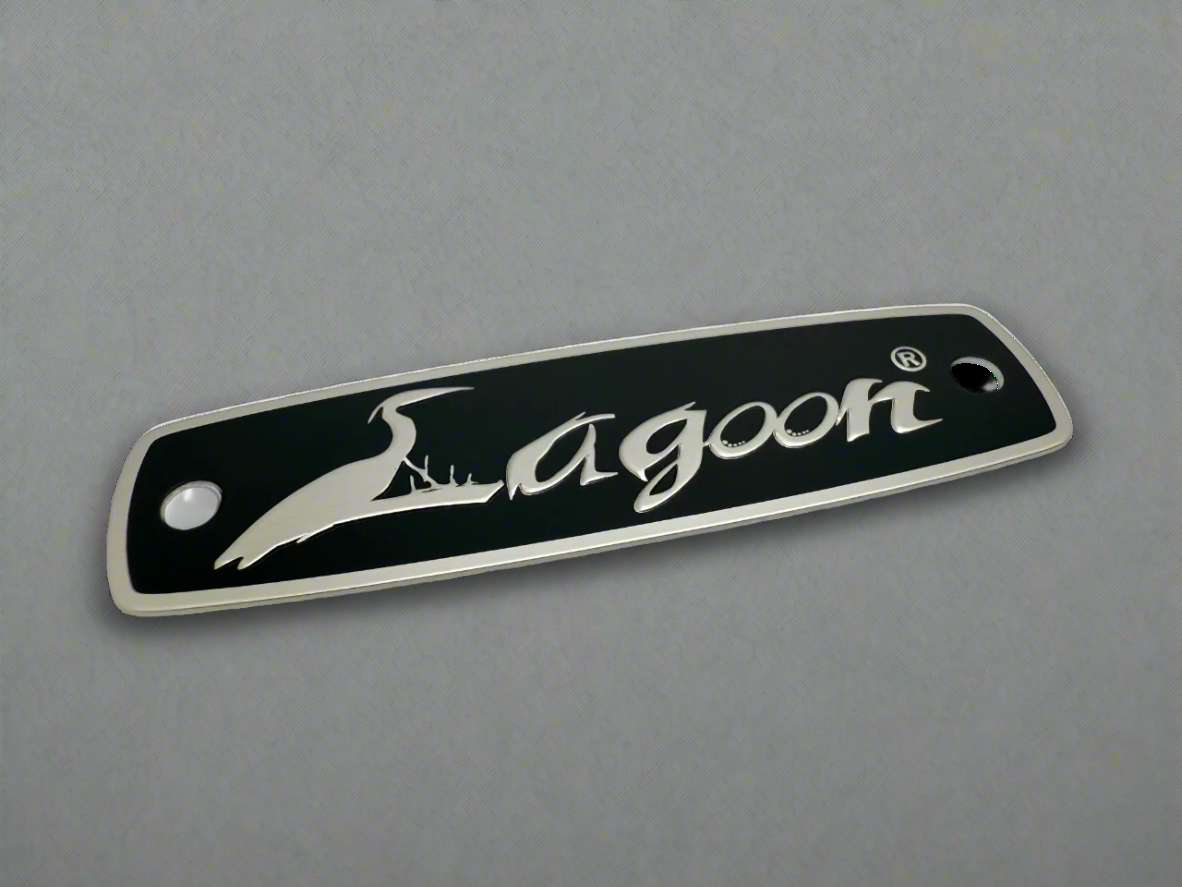 Furniture label with black screen printing, embossed border/logo and mounting holes. 
