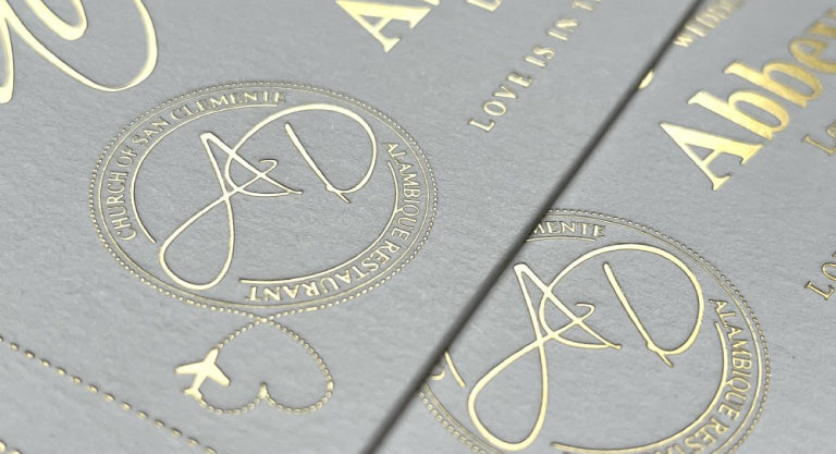 Hot foil printed labels made with a white background and gold design