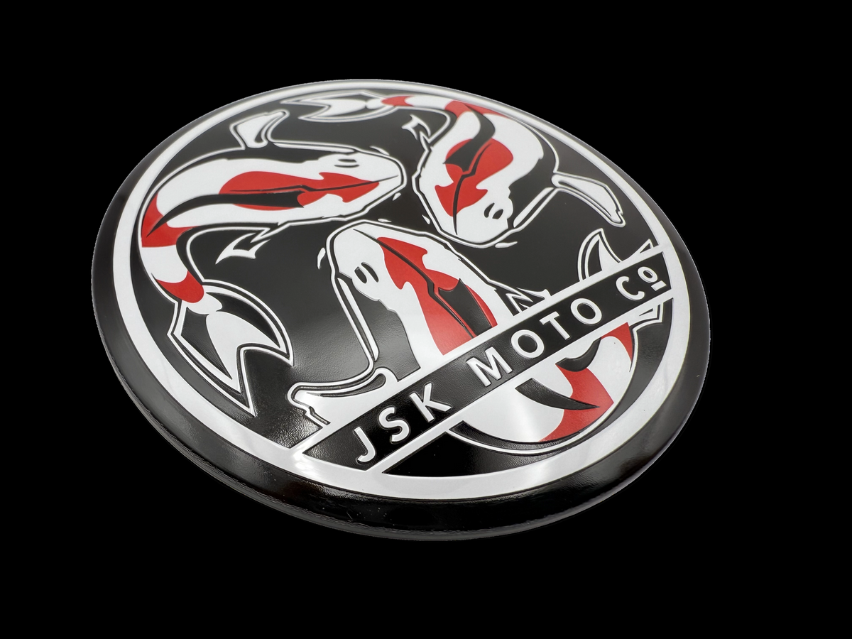 Motorcycle badge with embossing, printing & rolled edges. 