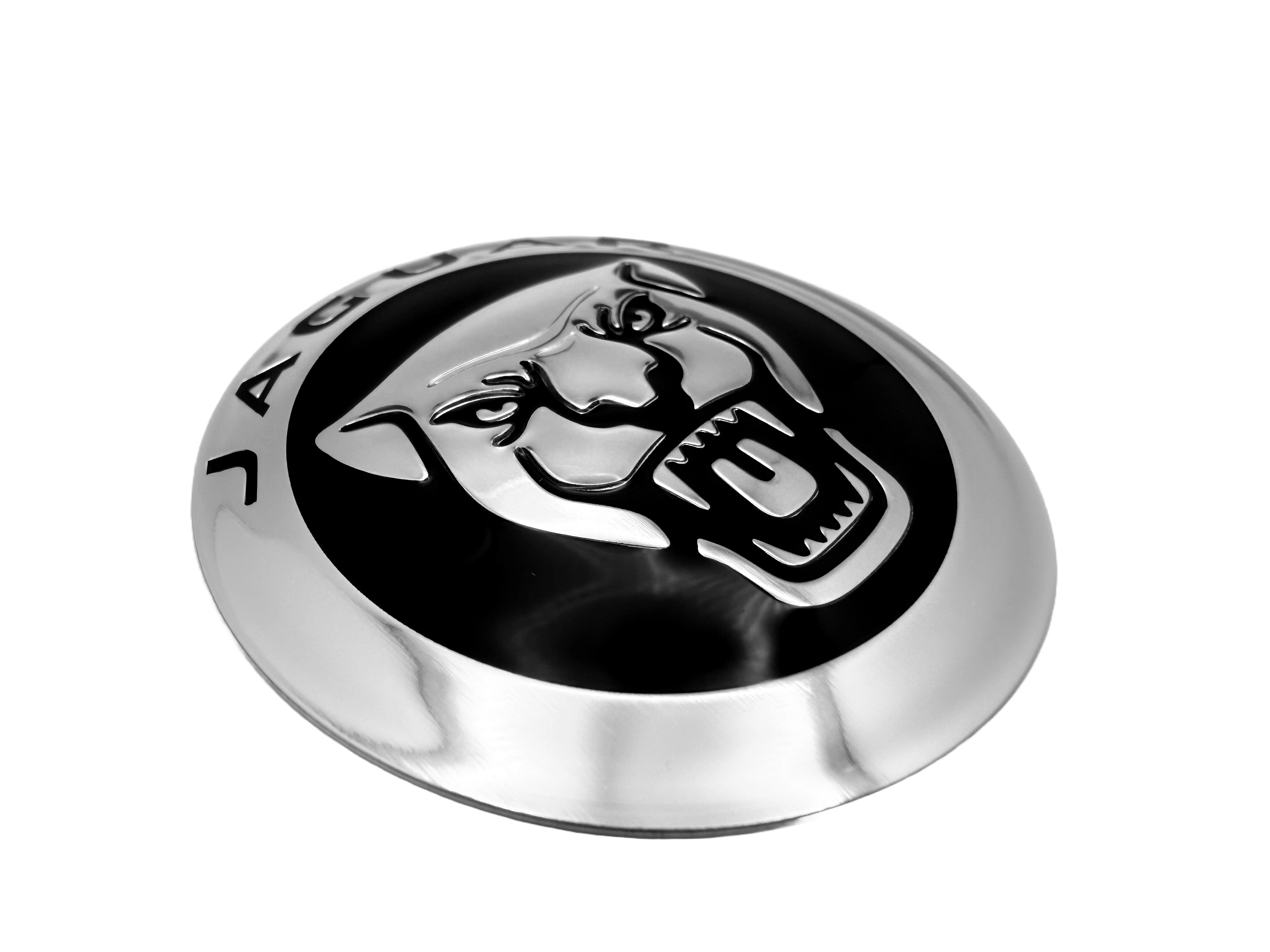 Jaguar truck badge fabricated from aluminum with screen printing, embossing, debasing and rolled edges