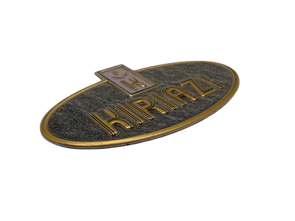 Aluminum label with screen printing that mimics the look of gold plating, embossing to the logo and lettering with gray textured background 