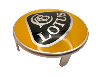 Lotus car badge with printed surface and tab attachments