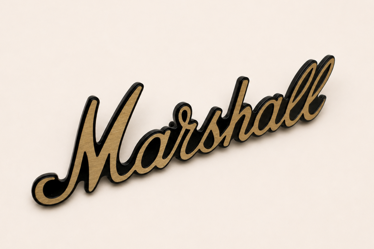 Forged aluminum electronics badge with anodizing and brushing