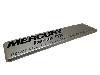 Marine badge produced using stamped aluminum with black printing and rolled edges.