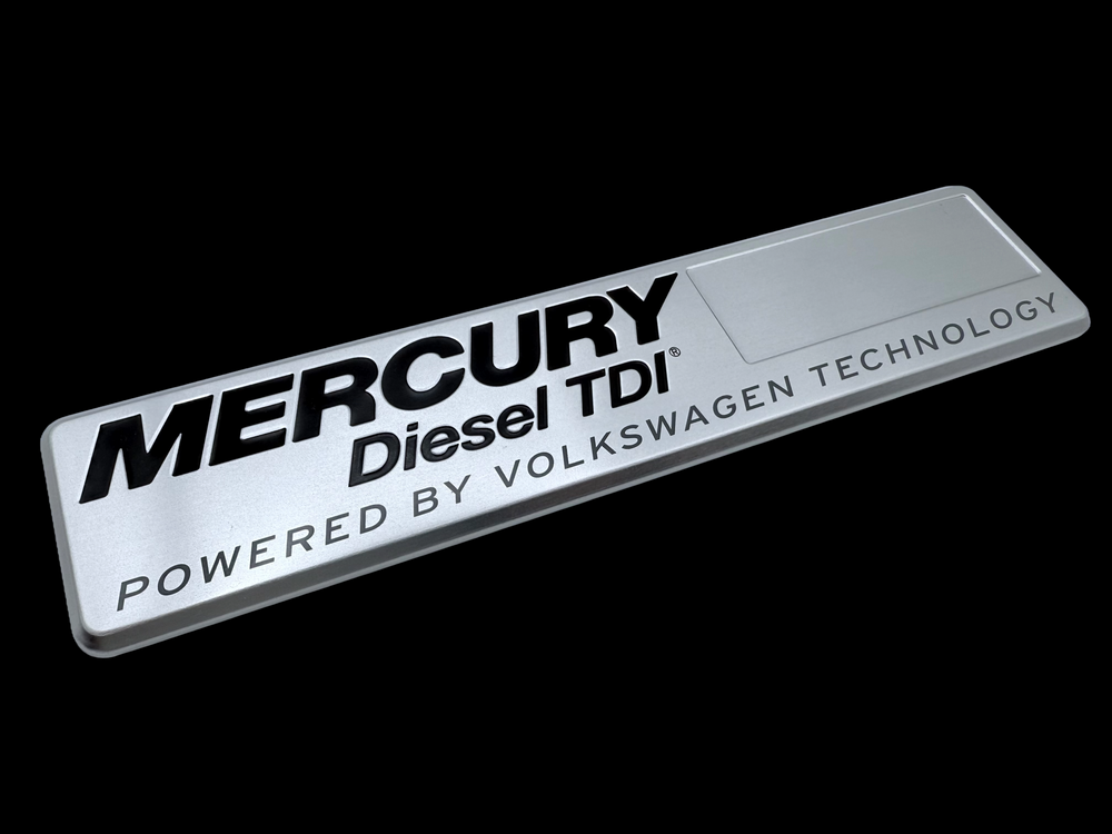 Mercury Diesel metal car logos produced using debossing, printing and rolled edges. 