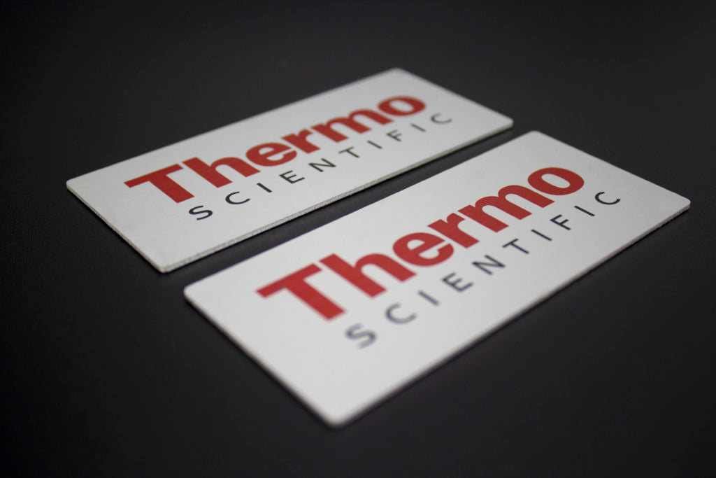Silver with black and red lettering industrial label used for branding