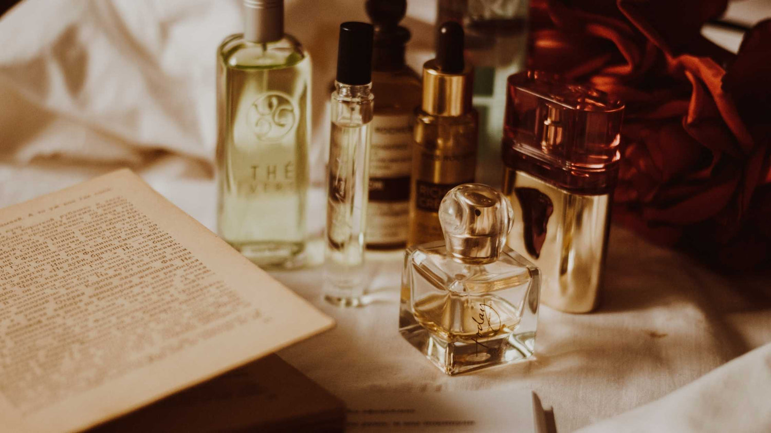 Collection of perfume bottles with different types of metal labels