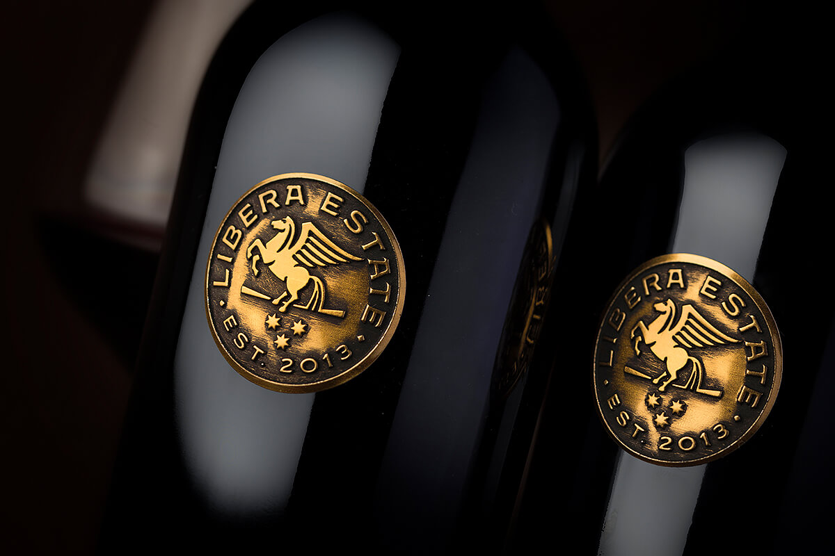 Custom coins on wine bottles