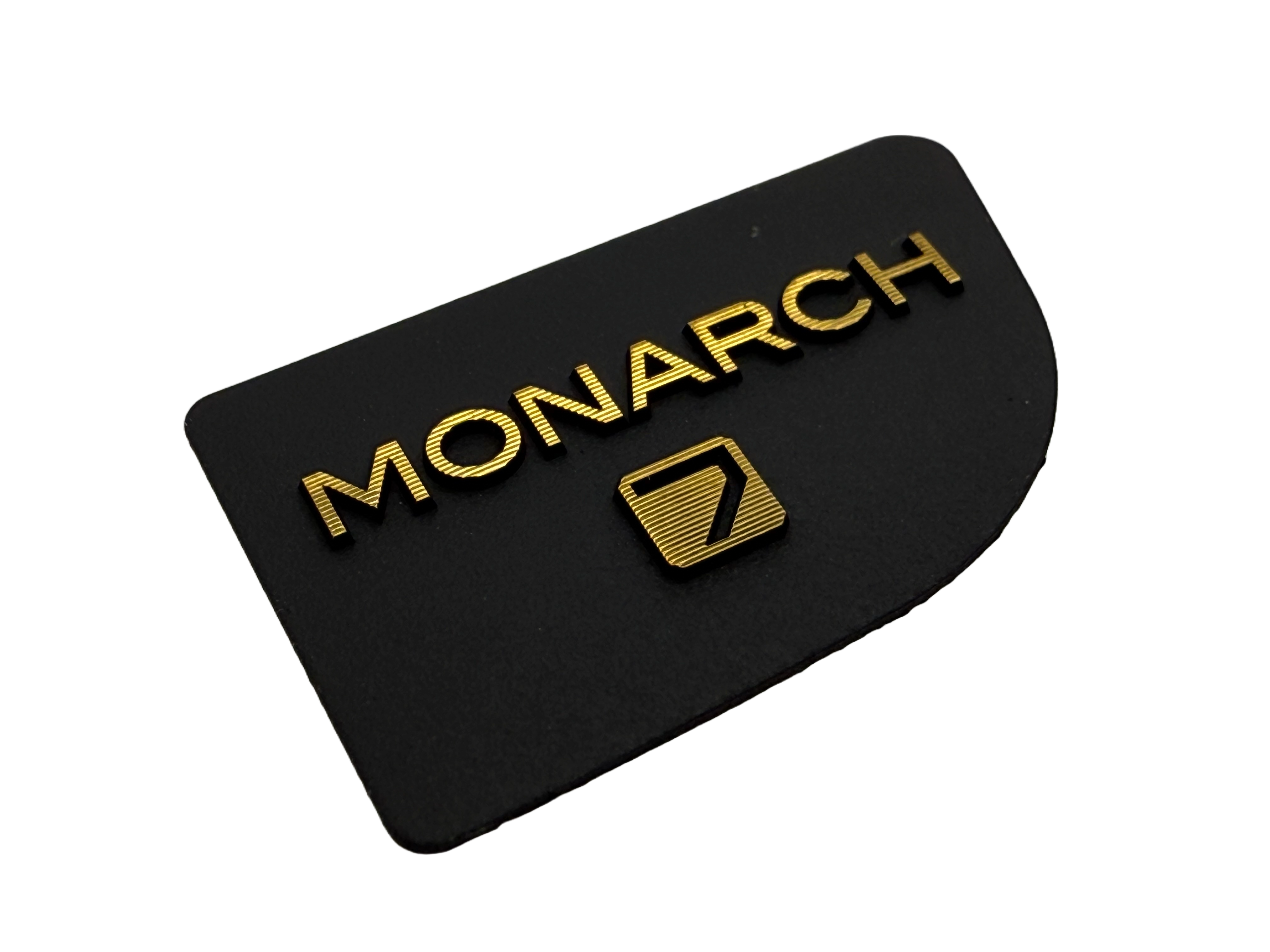 Thin electroformed badges with diamond cut text that reads 