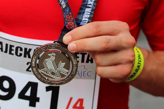 Runner holding up his medal after a race