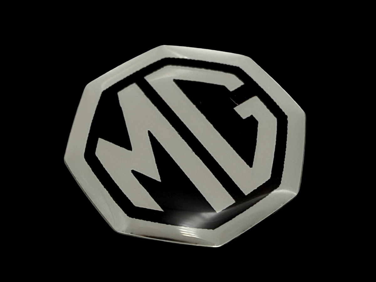 MG resin domed tag made using plastic, screen printing and electroplated chrome. 