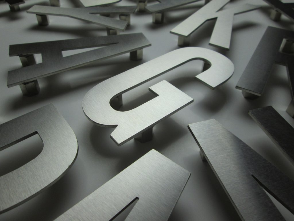 Collection of matte silver metal letters
