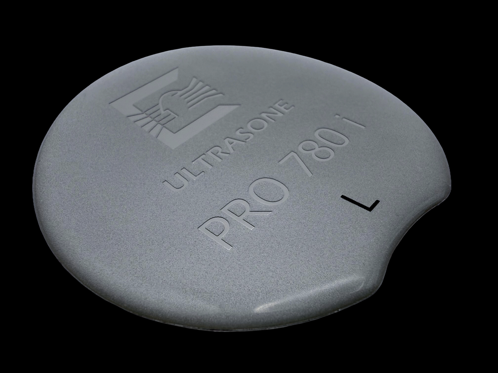 Plastic domed badge produced using metallic flake, embossing and printing. 