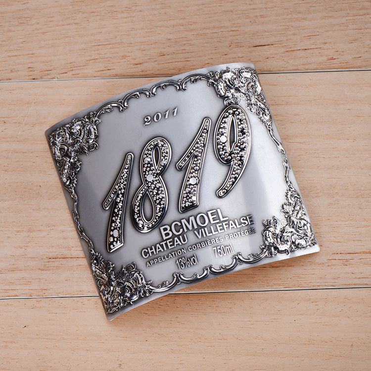 Stainless steel label with an embossed surface for wine bottles