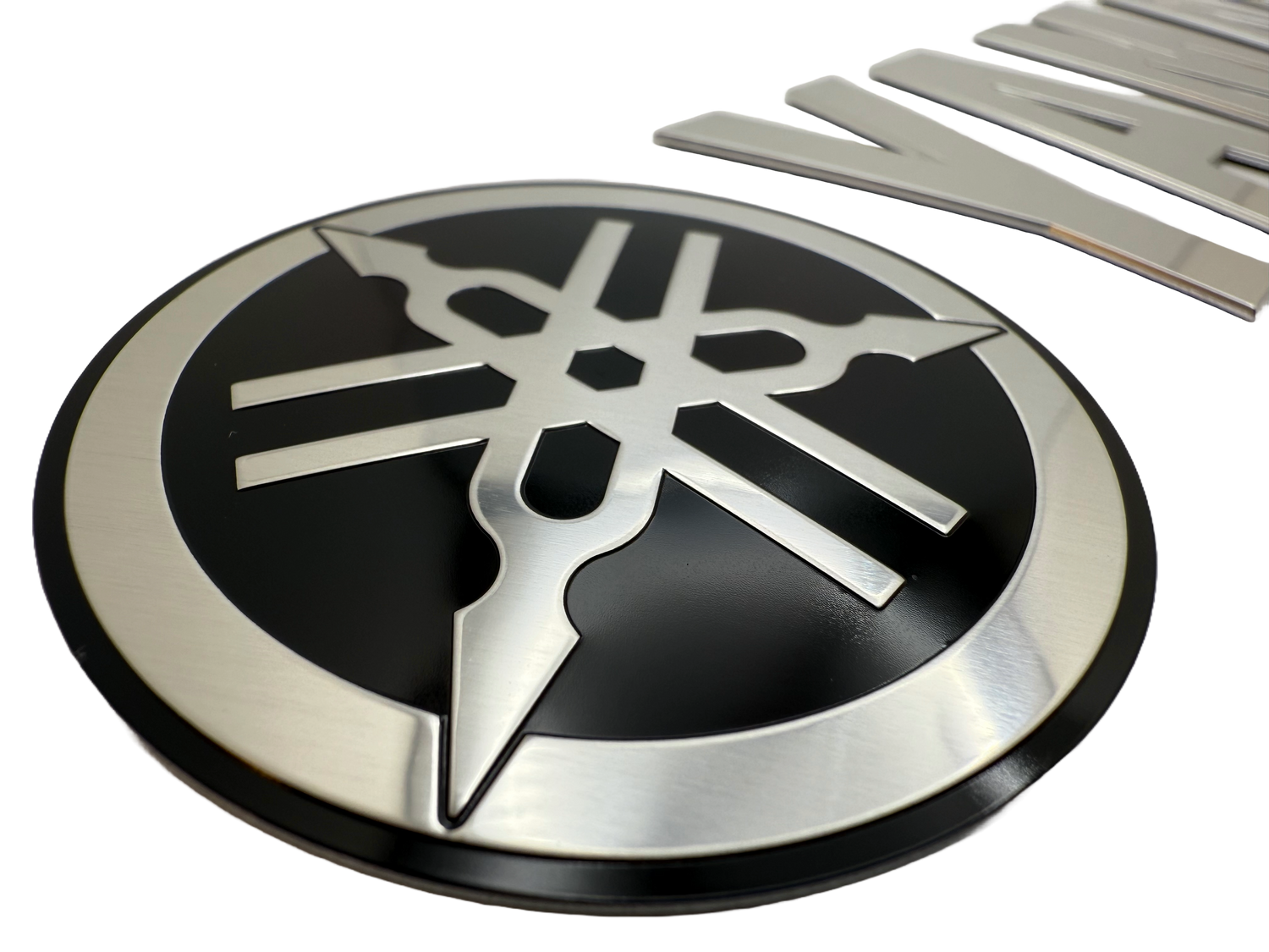 Boat badge made for branding. Logo and letters are stamped to shape. Boat lettering was produced using mirror aluminum