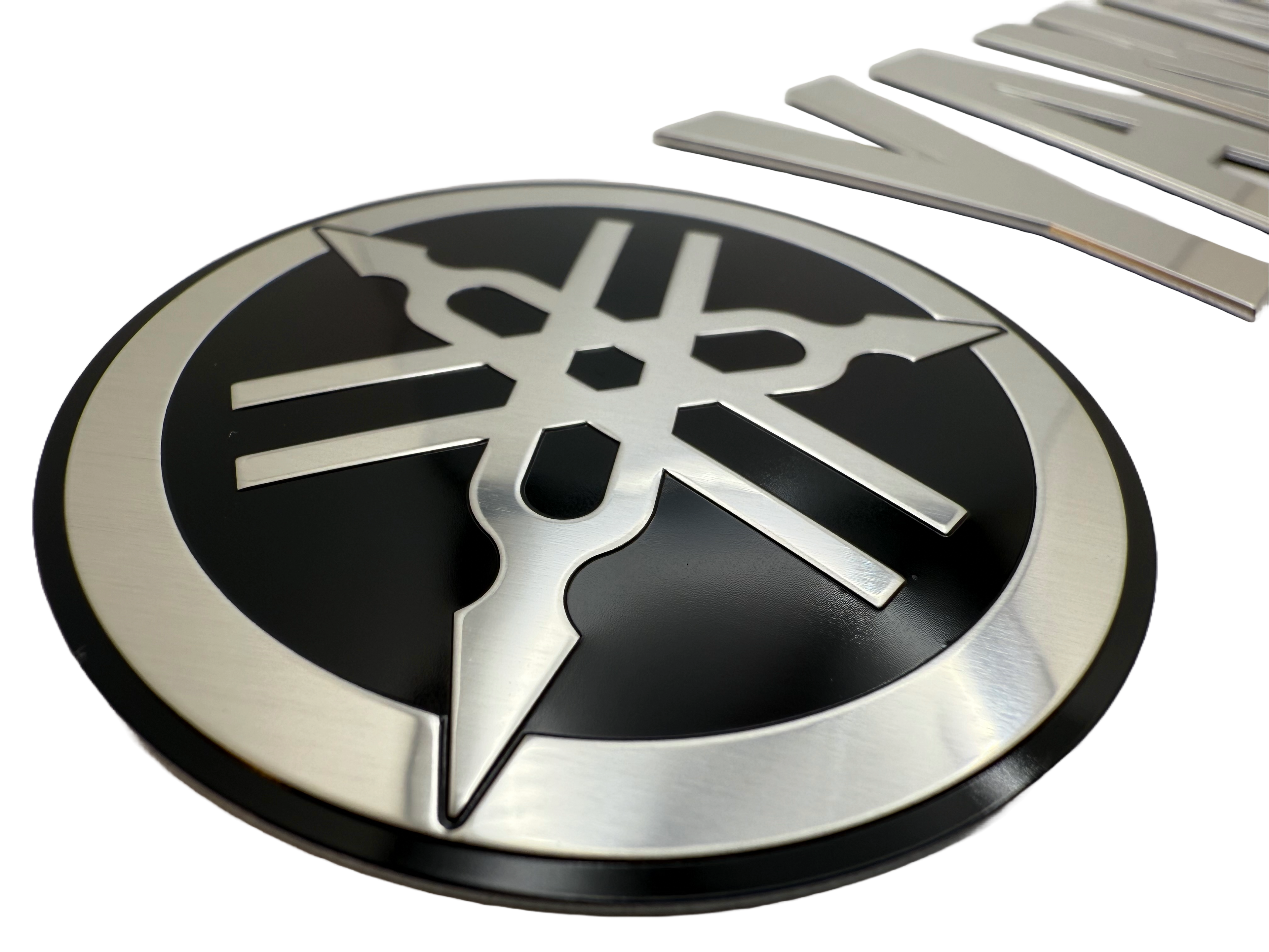 Boat badge made for branding. Logo and letters are stamped to shape. Boat lettering was produced using mirror aluminum