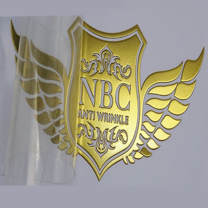 Gold wine label with wings made using electroforming