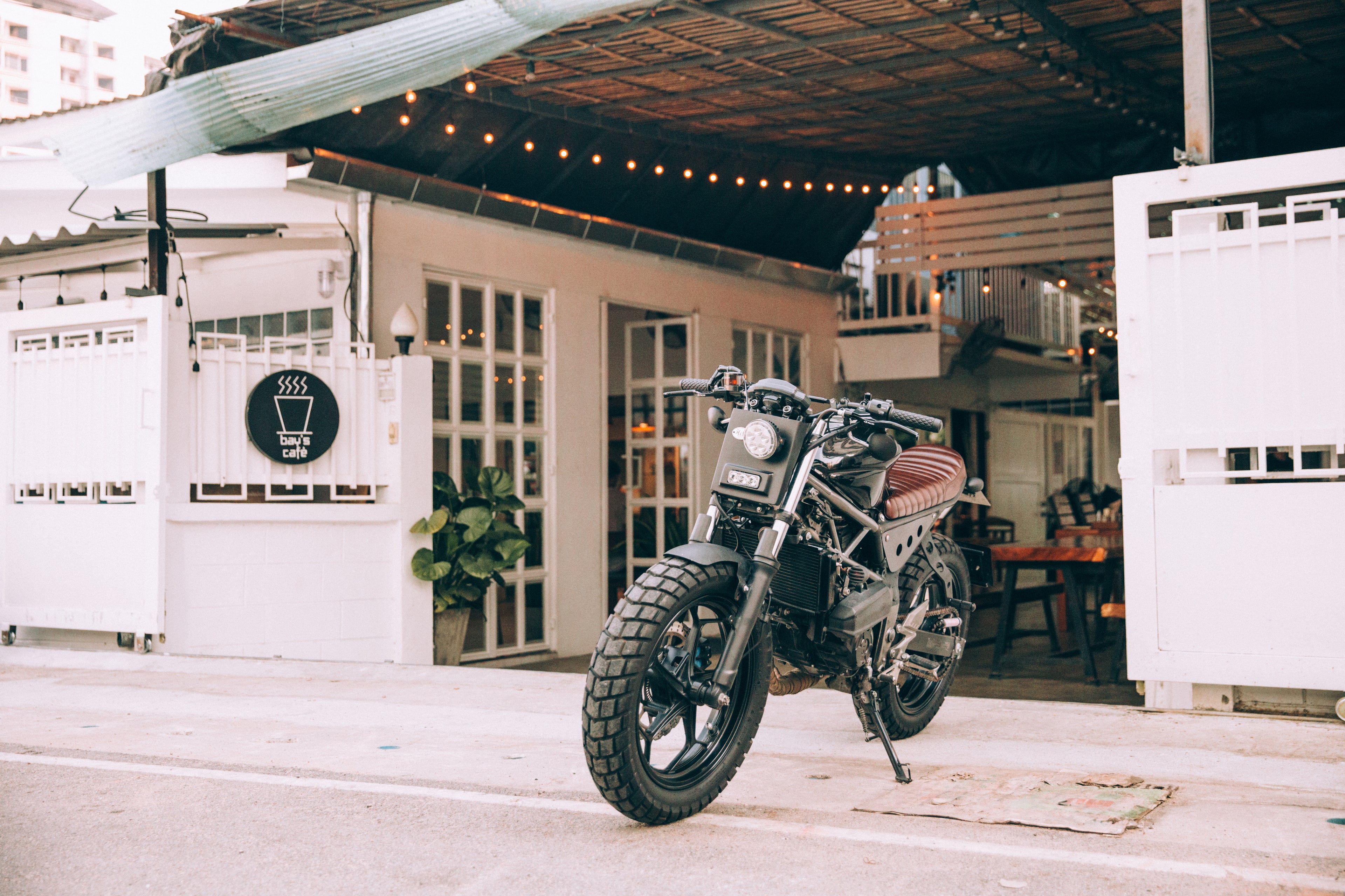 Motorcycle with a motorcycle badge on the side in front of a home